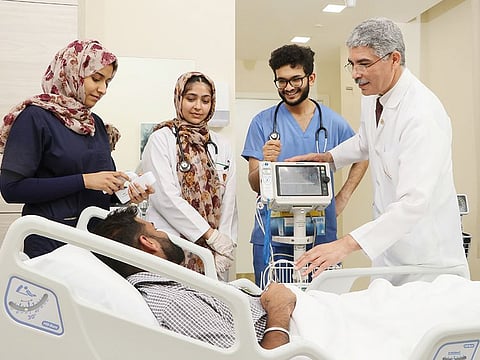 Doctor examines a patient in Thumbay University Hospital