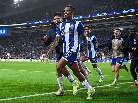 FC Porto's midfielder Wenderson Galeno celebrates scoring a goal during the Uefa Champions League last 16 first leg football match against Arsenal FC at the Dragao stadium in Porto on Wednesday.
