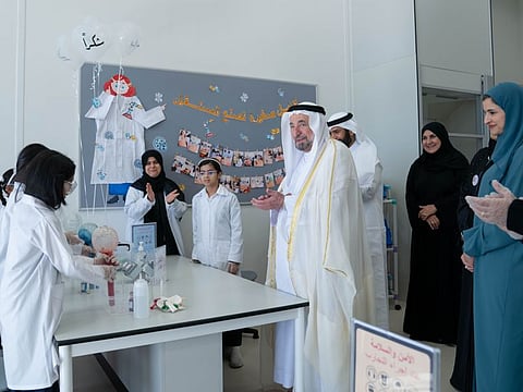 His Highness Dr Sheikh Sultan bin Mohammad Al Qasimi, Supreme Council Member and Ruler of Sharjah, interacts with students during the opening of a new school.
