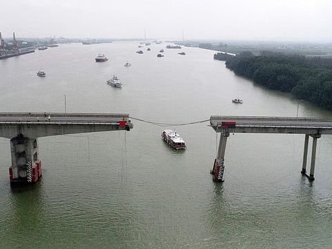In this photo released by Xinhua News Agency, ships sail near broken Lixinsha Bridge in Nansha District of Guangzhou, south China's Guangdong Province on February 22, 2024.