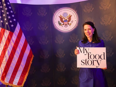 US Consul General Meghan Gregonis pose with the book "My Food Story at the United States National Day celebrations in Dubai. Photo: Virendra Saklani/Gulf News
