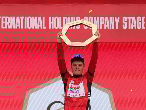 Lotto-DSTNY's Belgian cyclist Lennert Van Eetvelt lifts his trophy after winning the race of the 6th UAE Cycling Tour on Sunday.