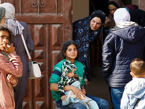 Palestinians react in the aftermath of an Israeli strike in Rafah on February 24, 2024.