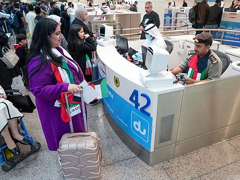 A Kuwaiti passenger (left) being welcomed by a passport control officer at DXB on Sunday