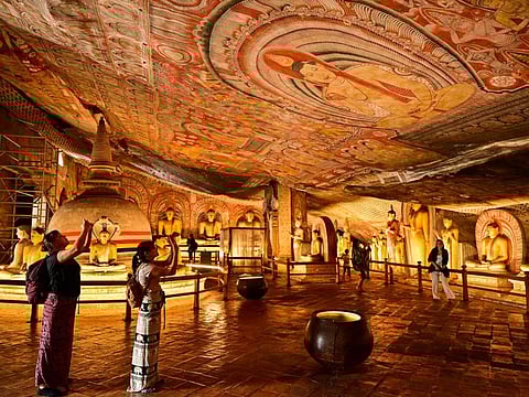 Foreign tourists visit the Rangiri Dambulla Cave Temple in Dambulla, some 150km (93 miles) north of Sri Lanka's capital Colombo on February 15, 2024. Just over 288,000 Russians and nearly 20,000 Ukrainians have visited Sri Lanka in the past two years, according to official figures.