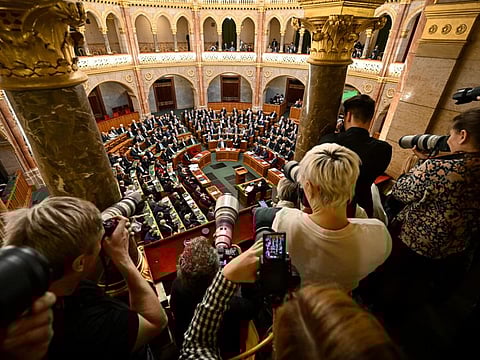 Photographers take pictures as Hungarian Prime Minister Viktor Orban stands after addressing a parliament session, on the day lawmakers approved Sweden's accession into Nato, in Budapest, Hungary, Monday, February 26, 2024.