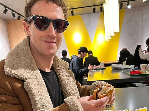 Mark Zuckerberg eating a burger.