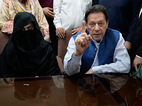 Imran Khan and Bushra Bibi speak to the media before signing documents to submit surety bond over his bails in different cases, at an office of Lahore High Court in Lahore, Pakistan, on July 17, 2023.