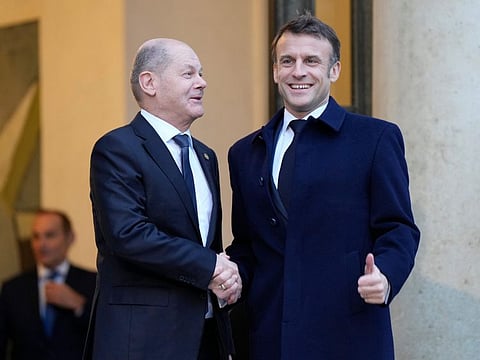 French President Emmanuel Macron, right, welcomes German Chancellor Olaf Scholz at the Elysee Palace in Paris.