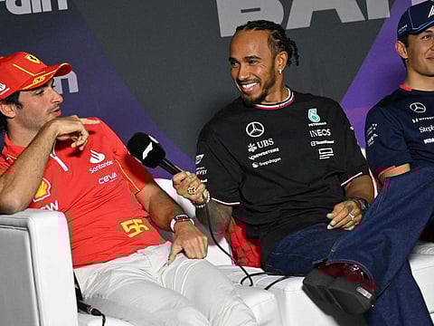 Ferrari's Spanish driver Carlos Sainz Jr (left) speaks as Mercedes' British driver Lewis Hamilton (centre) and Williams' Thai driver Alexander Albon smile during a press conference at the Bahrain International Circuit in Sakhir on Wednesday.