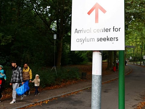 Migrants leave the arrival centre for asylum seekers at Berlin's Reinickendorf district, Germany.