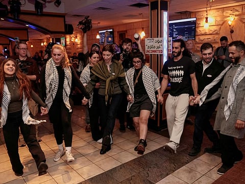 Attendees dance the Dabke during an uncommitted vote election night gathering as Democrats and Republicans hold their Michigan primary presidential election, in Dearborn, Michigan, on February 27, 2024.