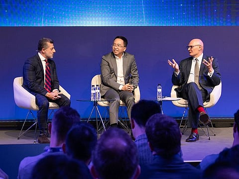 From left: Alex Katouzian, Group GM of MCX at Qualcomm Technologies, Inc., George Zhao, CEO of HONOR Device Co., Ltd., and John Hoffman, CEO of GSMA Ltd., during a panel discussion on AI at MWC 2024 in Barcelona.