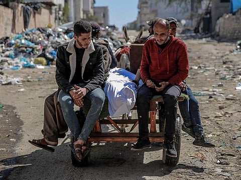 The body of a Palestinian killed in an early morning incident when residents rushed toward aid trucks in Gaza City on February 29, 2024. The health ministry in Hamas-run Gaza said Israeli forces shot dead dozens of people when a crowd rushed towards aid trucks on February 29.