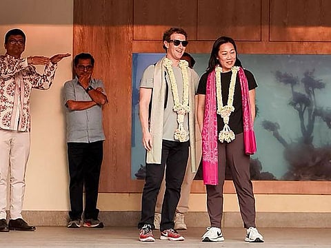 This handout photograph taken and released by Reliance on February 29, 2024, shows Meta chief Mark Zuckerberg (C) with his wife Priscilla Chan (2R) upon their arrival at Jamnagar Airport in Jamnagar, for a three-day celebration hosted by billionaire tycoon Mukesh Ambani.