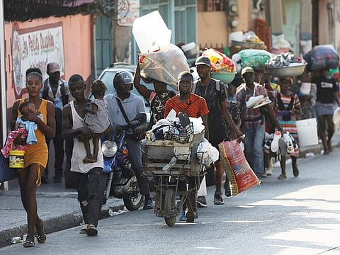 People flee their homes as police confront armed gangs after prominent gang leader Jimmy Cherizier called for Haiti's Prime Minister Ariel Henry's government to be toppled, in Port-au-Prince, Haiti, February 29, 2024.