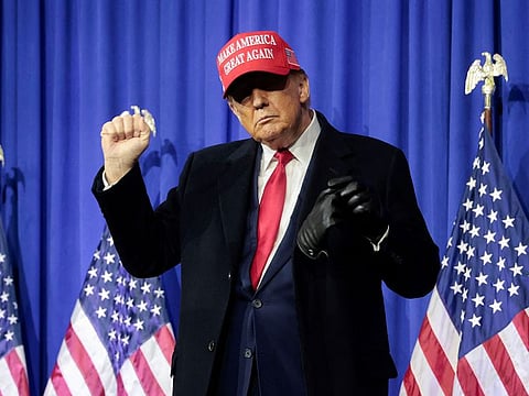 Former US President Donald Trump gestures during a campaign event in Waterford Township, Michigan.
