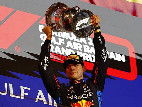 Red Bull's Max Verstappen celebrates with a trophy on the podium after winning the Bahrain Grand Prix.