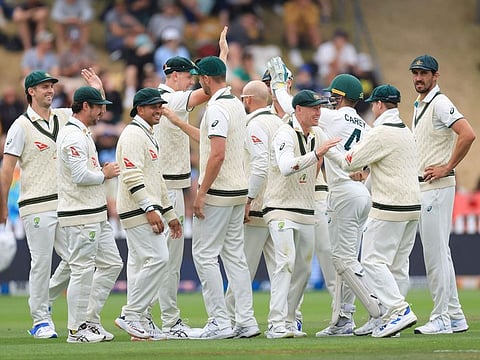 Australia celebrate New Zealand's Rachin Ravindra being caught during day four of the 1st Test at the Basin Reserve in Wellington on Sunday.
