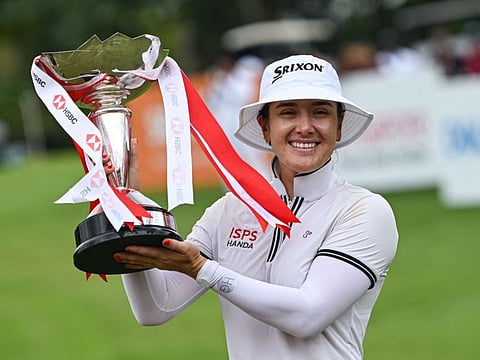Hannah Green of Australia with the trophy after winning the final round of the HSBC Women's World Championship golf tournament at Sentosa Golf Club in Singapore on Sunday.