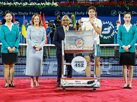 French tennis player Ugo Humbert (2nd R), showing the million-dollar ticket at the DDF draw, held after he won the Dubai Duty Free Tennis Championships Men’s final on Saturday night