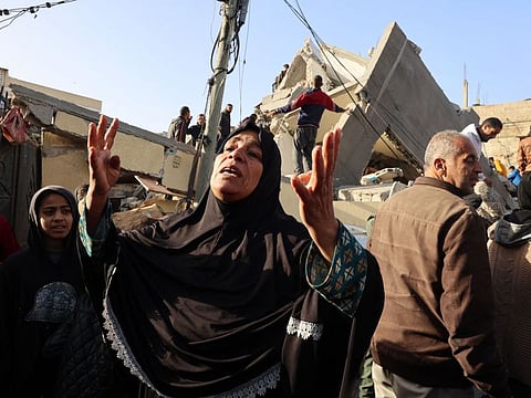 A Palestinian woman reacts in front of a house destroyed in an overnight Israeli air strike in Rafah in the southern Gaza Strip on March 3, 2024.
