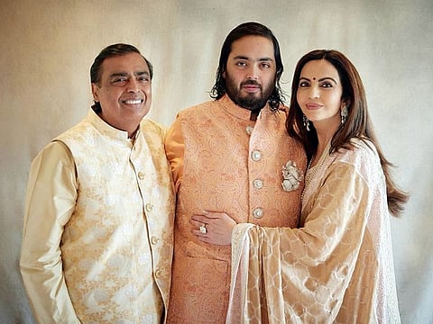 Reliance Industries Chairman Mukesh Ambani poses for a picture with Reliance Foundation Founder and Chairperson and his wife Nita Ambani and their son Anant Ambani during the pre-wedding bash of their son with Radhika Merchant, in Jamnagar on Saturday
