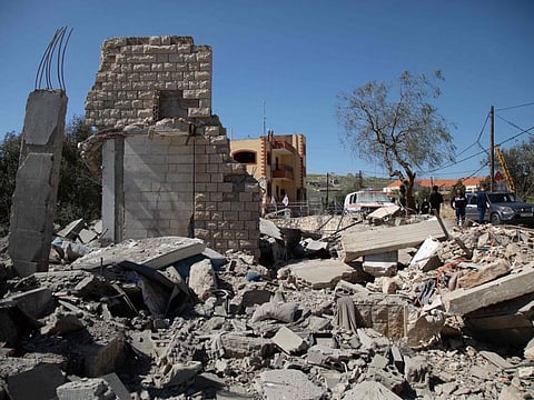 People inspect the site of an Israeli airstrike a day earlier in the southern Lebanese village of Odaisseh near the border with Israel on March 5, 2024.