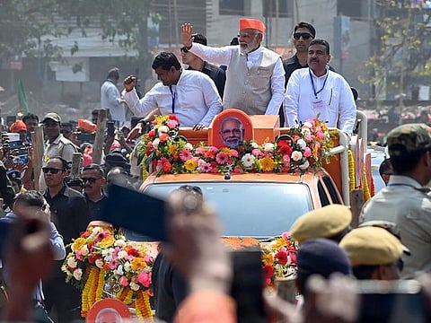 Prime Minister Narendra Modi waves to the gathering during a public rally at Krishnanagar