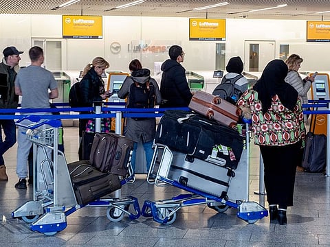 Passengers queue for information in a terminal at the airport in Frankfurt, Germany.