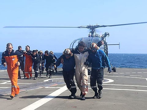 This handout photograph shows the rescue operation of crew members of a Barbados-flagged bulk carrier by Indian Navy after an attack by Yemen's Houthi militants, in the Gulf of Aden.