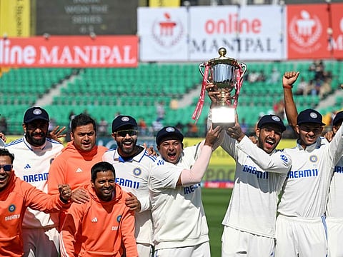 India's players with the trophy after winning the fifth and last Test cricket match against England at the Himachal Pradesh Cricket Association Stadium in Dharamsala on Saturday.