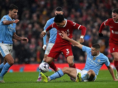 Manchester City's midfielder Mateo Kovacic vies with Liverpool's midfielder Wataru Endo during the English Premier League football match at Anfield in Liverpool on Sunday.