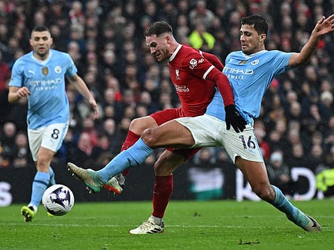 Manchester City's midfielder Rodri (right) vies with Liverpool's midfielder Alexis Mac Allister during the English Premier League football match at Anfield on Sunday.
