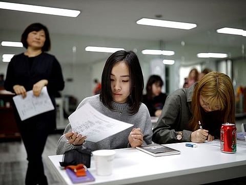 Japanese Yuuka Hasumi, 17, and Yuho Wakamatsu, 15, attend a Korean language class in Seoul, South Korea.