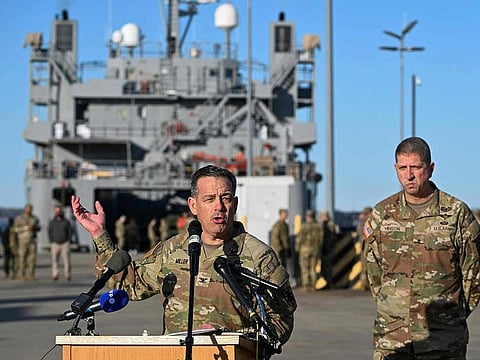 US Army Colonel Sam Miller, Commander of the 7th Transportation Brigade (Expeditionary) speaks to members of the press near four US Army ships before they depart to Gaza from the Joint Base Langley-Eustis during a media preview of the 7th Transportation Brigade deployment in Hampton, Virginia, on March 12, 2024.
