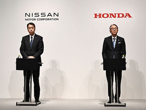 Makoto Uchida, president and CEO of Nissan (L) and Toshihiro Mibe, Honda director, president and representative executive officer attend a joint press conference in Tokyo on March 15, 2025. Japanese auto giants Nissan and Honda said on March 15 they had agreed to explore a strategic partnership in electric vehicles and other areas.