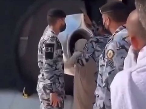 Screengrab from a video showing a young girl kissing Kaaba.