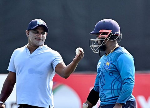 Sri Lanka's Charith Asalanka (right) and team consultant Sanath Jayasuriya speak during a practice session at the Zahur Ahmed Chowdhury Stadium in Chittagong on Sunday.