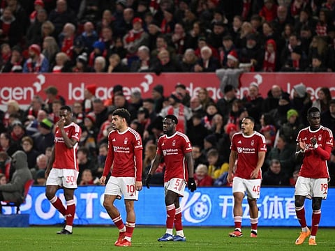 Forest players react to conceding the first goal during the English Premier League football match against Tottenham Hotspur.