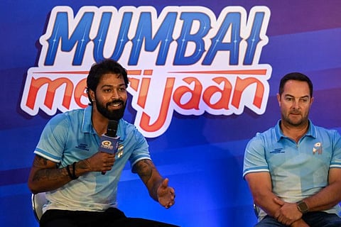 Mumbai Indians' captain Hardik Pandya (left) speaks as coach Mark Boucher look on during a press conference in Mumbai on Monday.