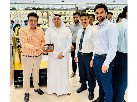 Vinay Jethwani with a DED official and Sanjay Jethwani, Sahil Jethwani during the announcement of Dh50,000 cash priza winner