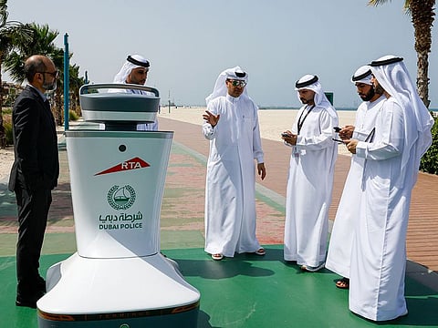 Roads and Transport Authority (RTA) officials with the smart robot in Jumeirah 3 beach area on Thursday.