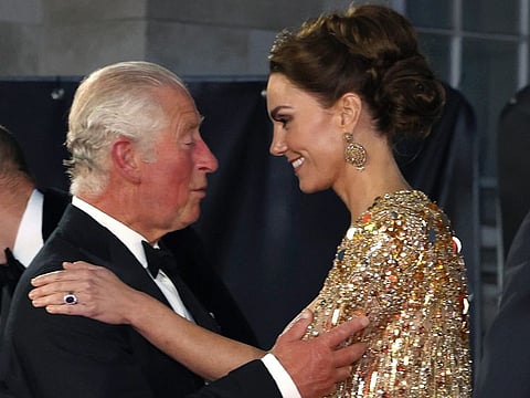 In this Tuesday, September 28, 2021 photo, Britain's Prince Charles speaks with Kate as they arrive for the World premiere of the new film from the James Bond franchise 'No Time To Die', in London.