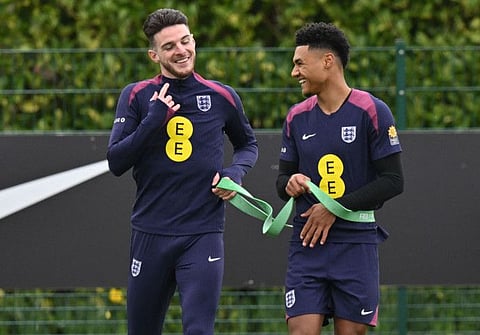England's midfielder Declan Rice (left) and striker Ollie Watkins chat during a team training session at the Tottenham Hotspur Training Ground, in Enfield, north London on Monday.