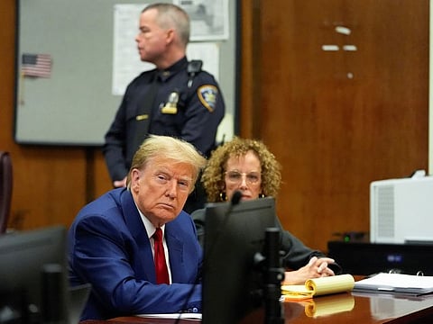 Former US President Donald Trump awaits the start of a pre-trial hearing, on charges stemming from hush money paid to a porn star, in New York City, on March 25, 2024.