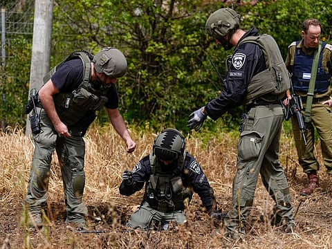 Israeli security forces examine the site hit by a rocket fired from Lebanon, in Kiryat Shmona, northern Israel on  March 27, 2024.