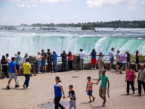 Tourist take photos in front of Niagara Falls in Niagara Falls, Ontario, Canada June 28, 2022.