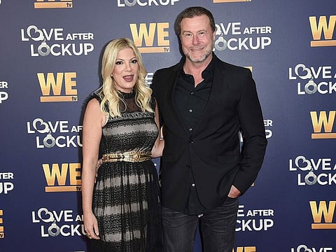 Tori Spelling, left, and Dean McDermott attend Real Love: Relationship Reality TV's Past, Present and Future on Dec. 11, 2018, in Beverly Hills, Calif. Spelling filed for divorce Friday from her husband and former reality TV co-star McDermott.