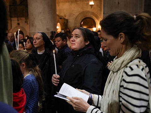 Worshippers pray at the Church of the Holy Sepulchre in the Old City of Jerusalem, during the Easter Sunday mass on March 31, 2024.